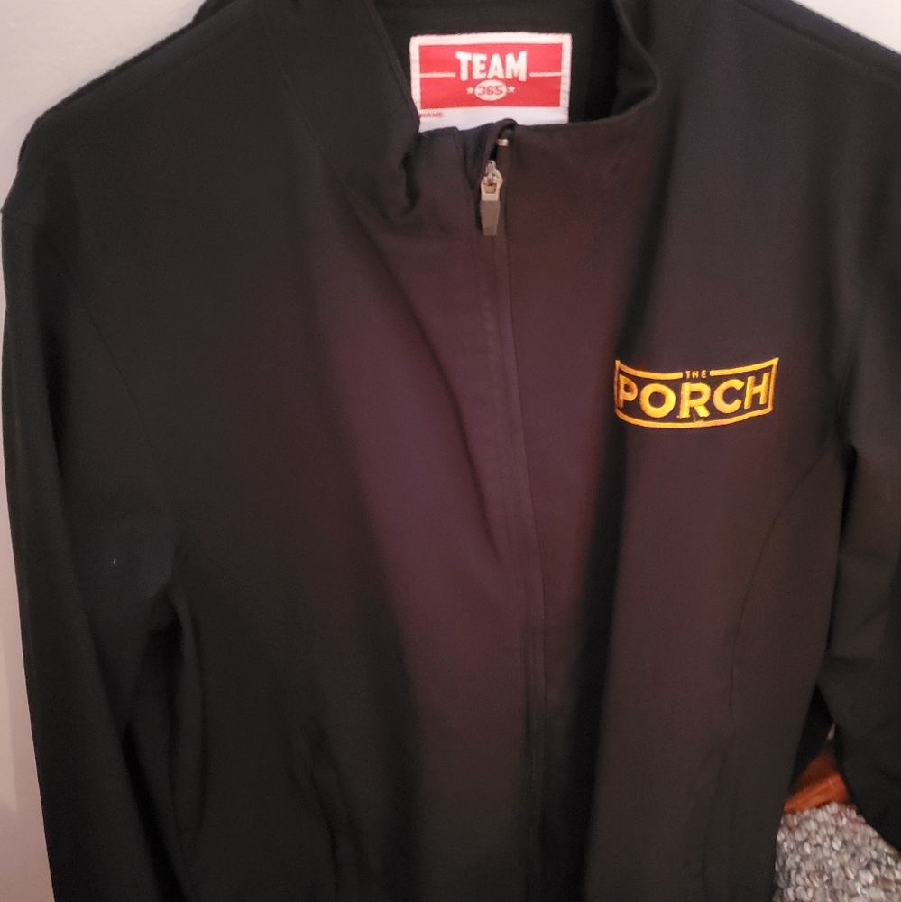 Really nice black jacket that says "the porch"